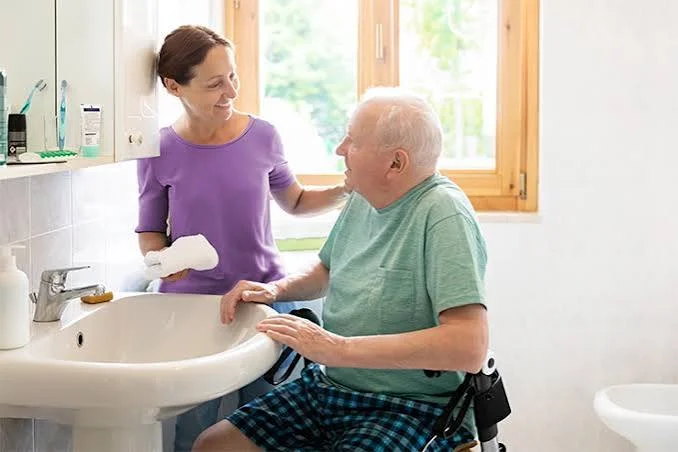 Aidant accompagnant un senior dans une salle de bain sécurisée